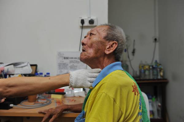 电流点穴除了医治奇难杂症,对于一些小毛病也很有效,如这位老伯便因喉咙痛而来进行电流点穴。