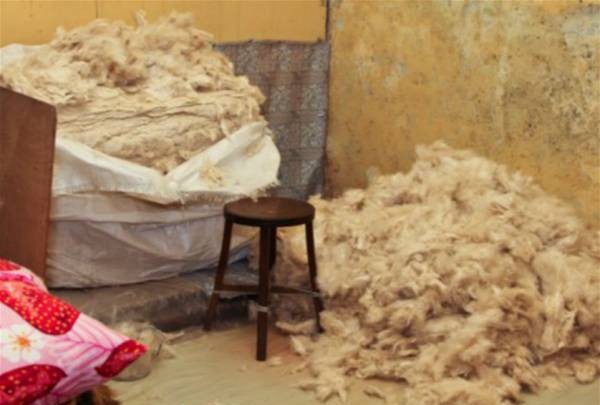 小房间里囤积大量的木棉，小小的空间闷热又木棉花絮随风飞，工作环境条件甚是艰苦。