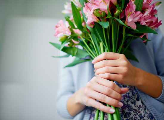 Close-up of bunch of fragile lilies in female hands