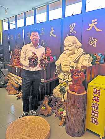 怡保大黑天财神艺术馆馆长吴进益手捧大黑天财神,娓娓向记者叙述它的种种神迹。