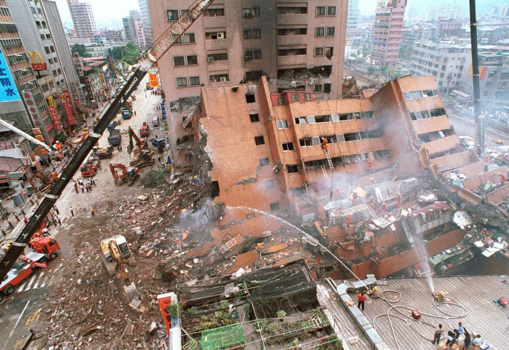 A hotel complex lies crumbled and destroyed in Taipei, Taiwan, following a 7.6 magnitude earthquake which struck early Tuesday, Sept. 21, 1999.  Cost cutting by contractors is being blamed by many officials for the collasped of many newer building.  (AP Photo/Wally Santana)