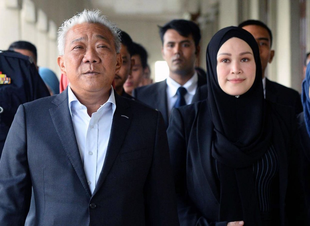 Kinabatangan MP Datuk Seri Bung Moktar Radin with wife Datin SerI Zizie Ezette walking out after being charged at the Kuala Lumpur court in Jalan Duta. AZHAR MAHFOF/The Star