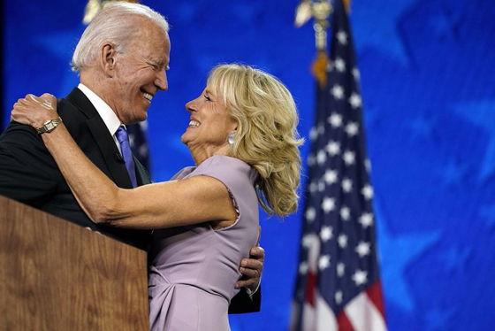 Democratic presidential candidate former Vice President Joe Biden hugs his wife Jill Biden after speaking during the fourth day of the Democratic National Convention, Thursday, Aug. 20, 2020, at the Chase Center in Wilmington, Del. (AP Photo/Andrew Harnik)