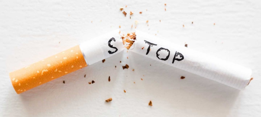 broken cigarette with the word stop. stop smoking concept closeup