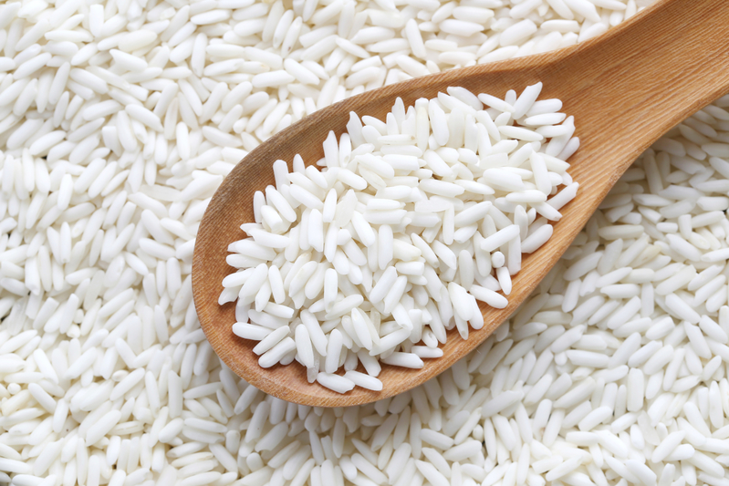 Organic white rice in wooden spoon, glutinous rice or sticky ric