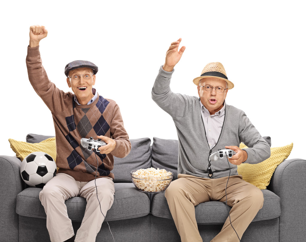 Two seniors playing football video game