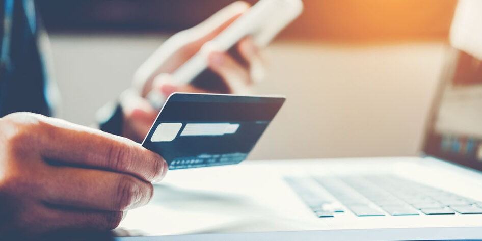 Man Holding Credit Card And Using Cell Phone holding credit card with shopping online