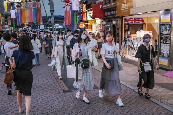 Pedestrians wearing face masks as a precaution against the spread of covid-19 walk in the streets of Shibuya, amid the covid-19 pandemic. (Photo by Stanislav Kogiku / SOPA Images/Sipa USA)
