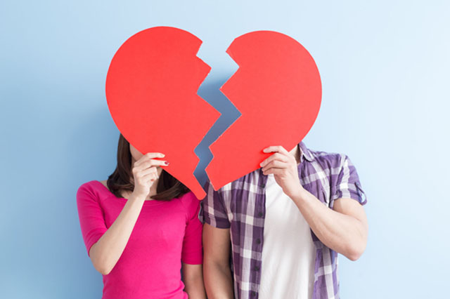 Young,Couple,Take,Broken,Heart,Isolated,On,Blue,Background